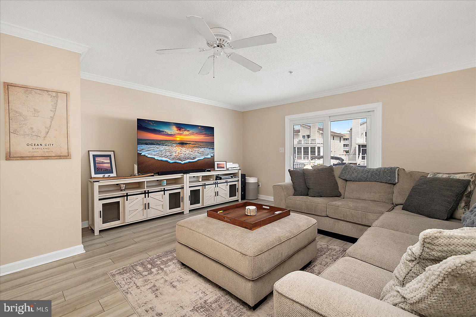 712 Bradley Road, Unit E Ocean City, MD 21842 - Photo 7 of 48 a living room with furniture and a flat screen tv