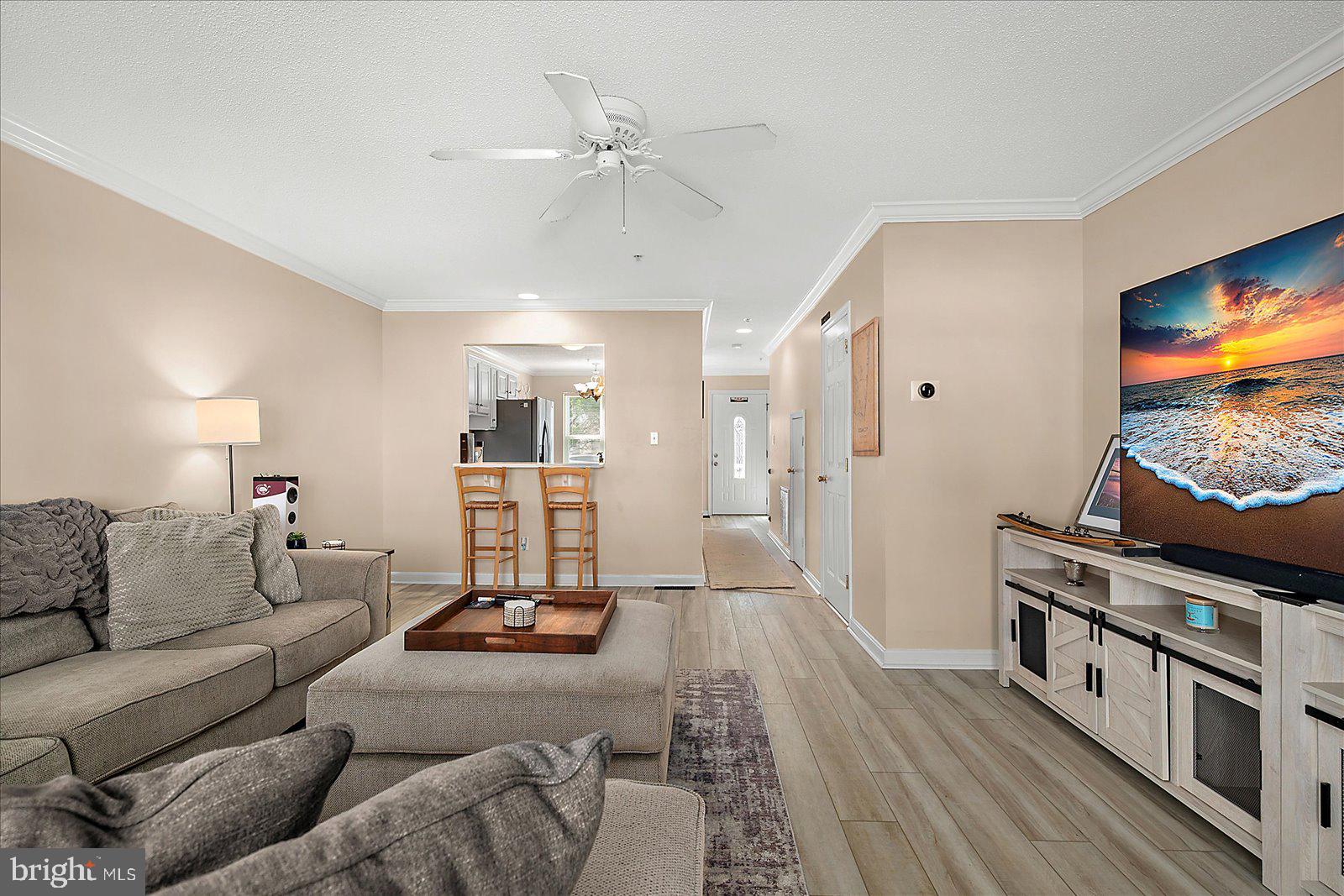 712 Bradley Road, Unit E Ocean City, MD 21842 - Photo 9 of 48 a living room with furniture and a flat screen tv