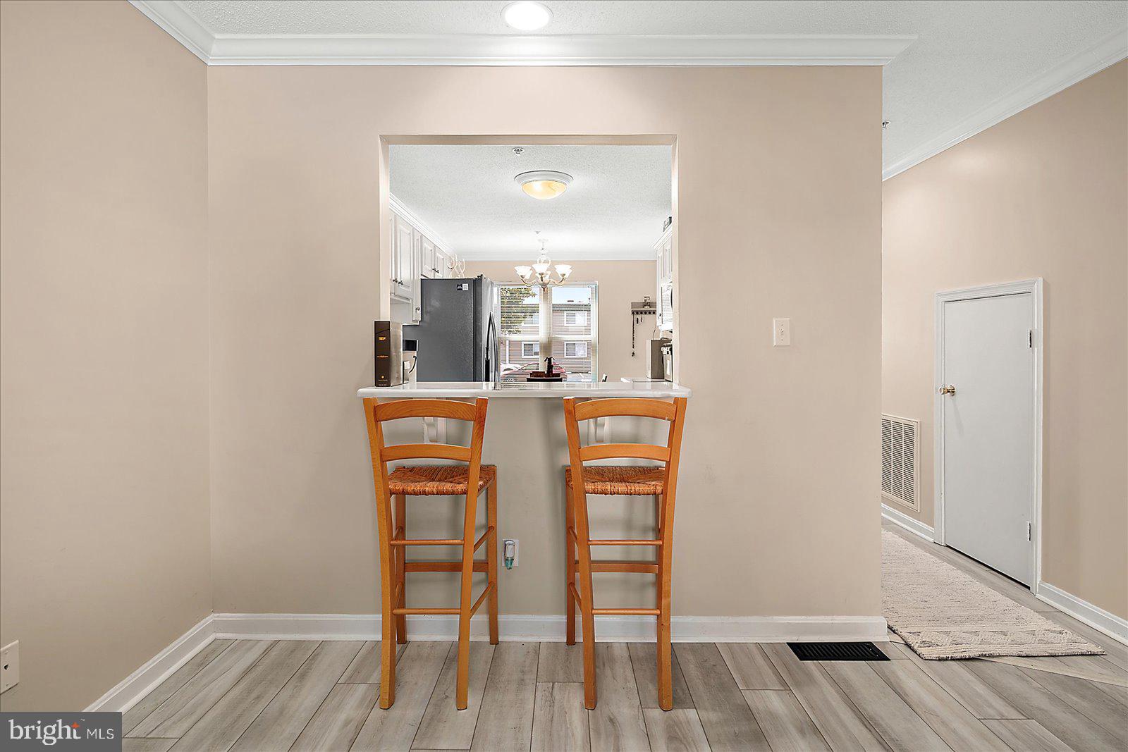 712 Bradley Road, Unit E Ocean City, MD 21842 - Photo 10 of 48 a dining room with furniture and wooden floor