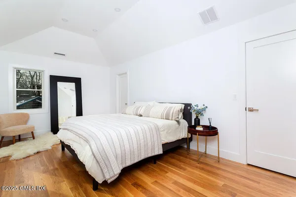 a bedroom with a bed and window