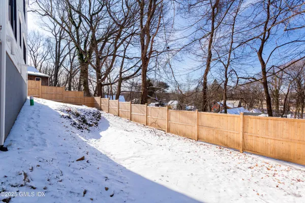 a view of yard covered with snow in front of house