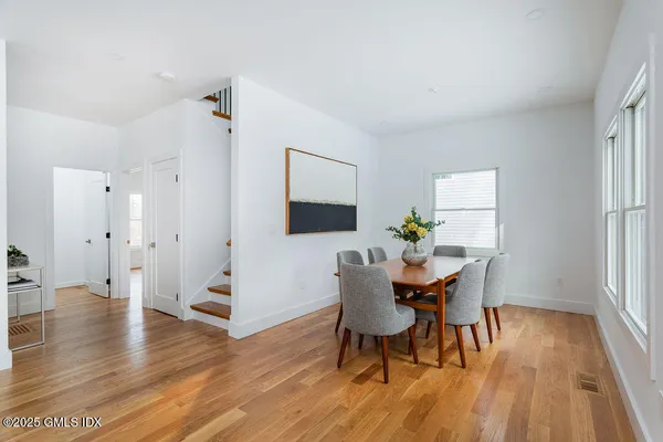 a view of a dining room with furniture and wooden floor