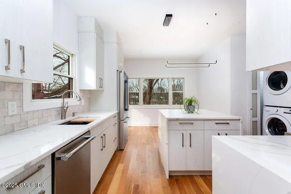 a kitchen with a sink stove and cabinets