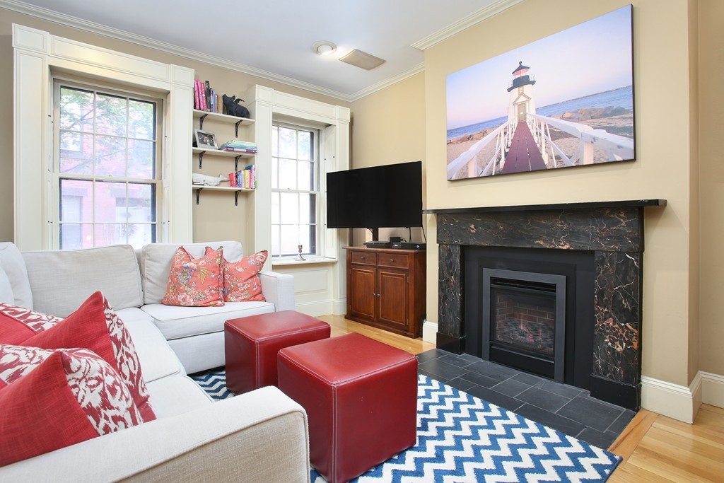9 Fayette Street, Unit 1 Boston, MA 02116 - Photo 1 of 6 a living room with furniture and a fireplace
