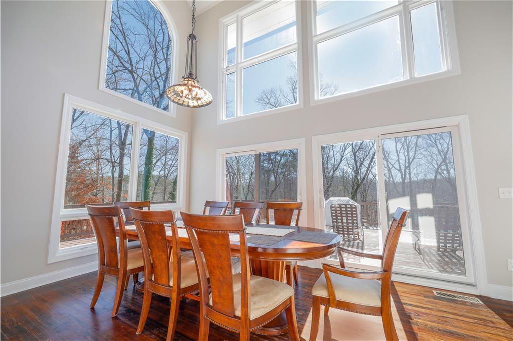 5997 Warpath Road Flowery Branch, GA 30542 - Photo 22 of 76 a view of a dining room with furniture wooden floor and a chandelier