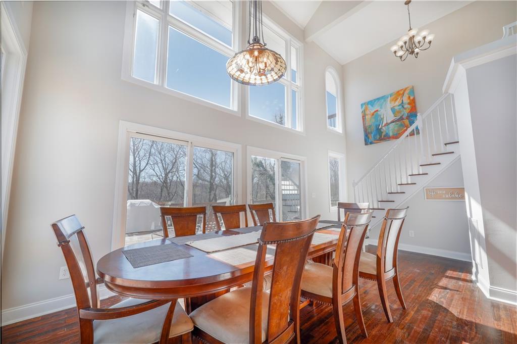 5997 Warpath Road Flowery Branch, GA 30542 - Photo 23 of 76 a view of a dining room with furniture and chandelier