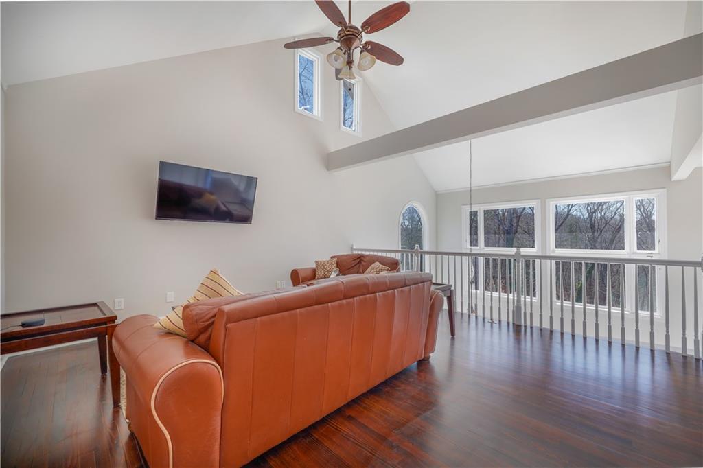 5997 Warpath Road Flowery Branch, GA 30542 - Photo 39 of 76 a living room with furniture and a flat screen tv