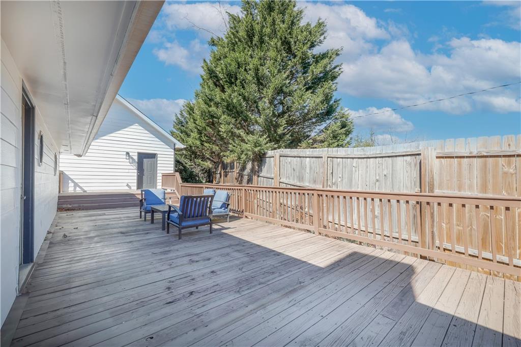 5997 Warpath Road Flowery Branch, GA 30542 - Photo 42 of 76 a view of a chairs and table on the wooden floor