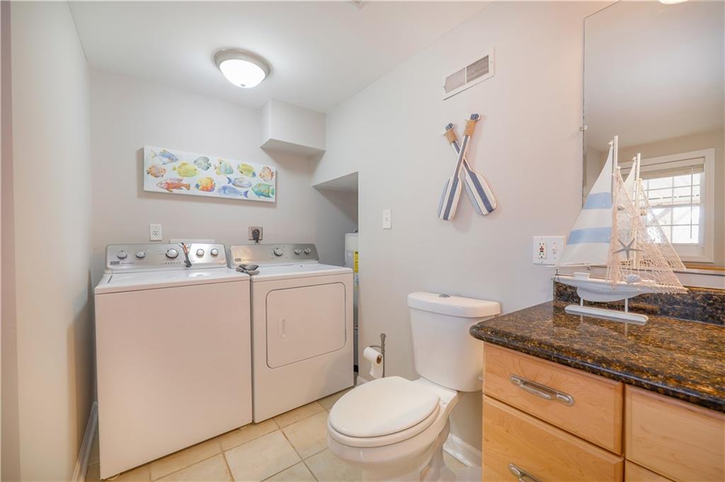 5997 Warpath Road Flowery Branch, GA 30542 - Photo 55 of 76 a bathroom with a granite countertop toilet sink and mirror