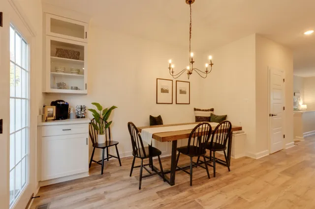 a view of a dining room with furniture and chandelier