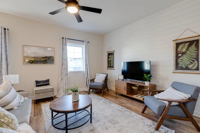 a living room with furniture and a flat screen tv
