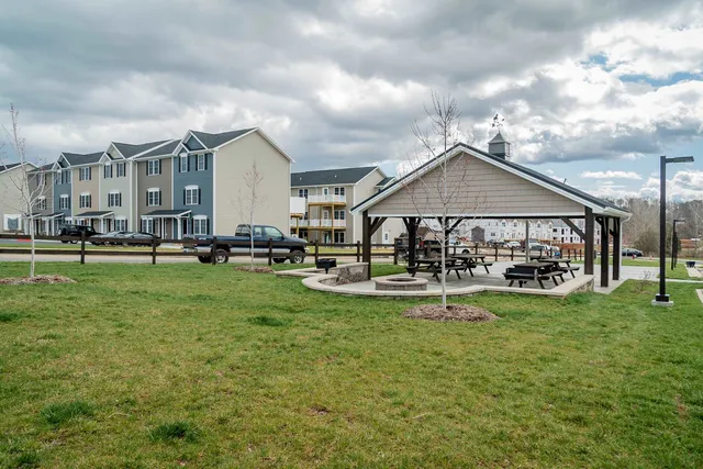 a view of a house with swimming pool and sitting area