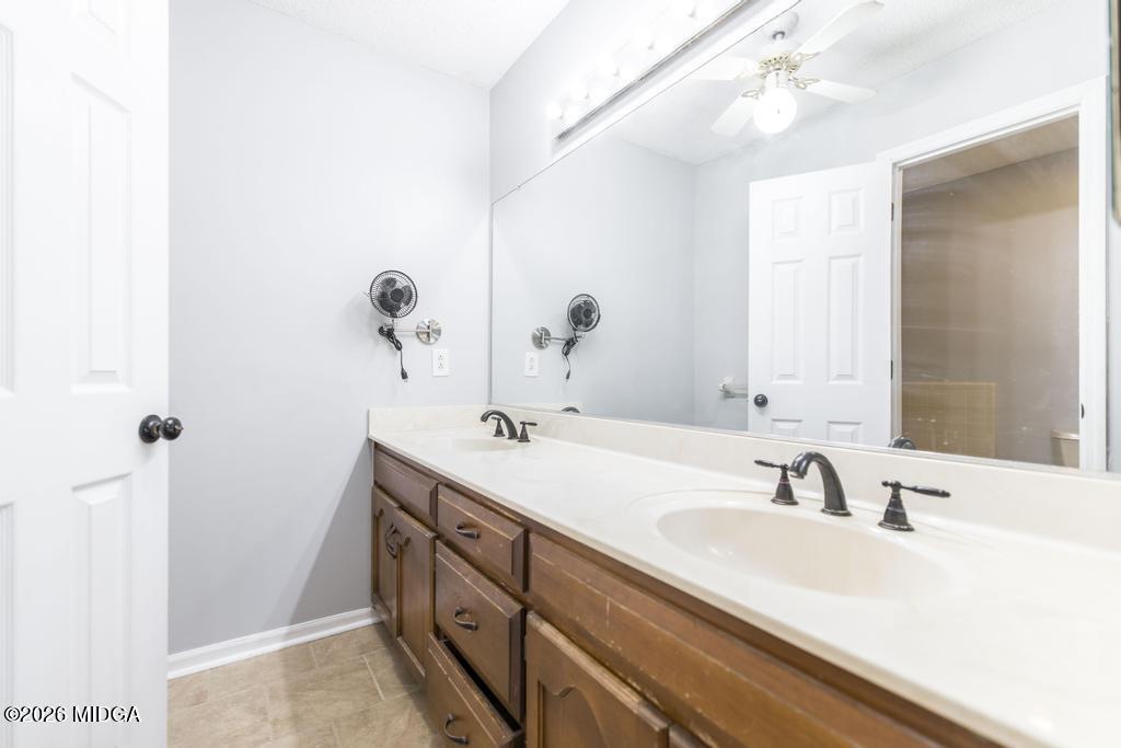 3710 Sandy Circle Macon, GA 31216 - Photo 25 of 44 a bathroom with a double vanity sink and mirror