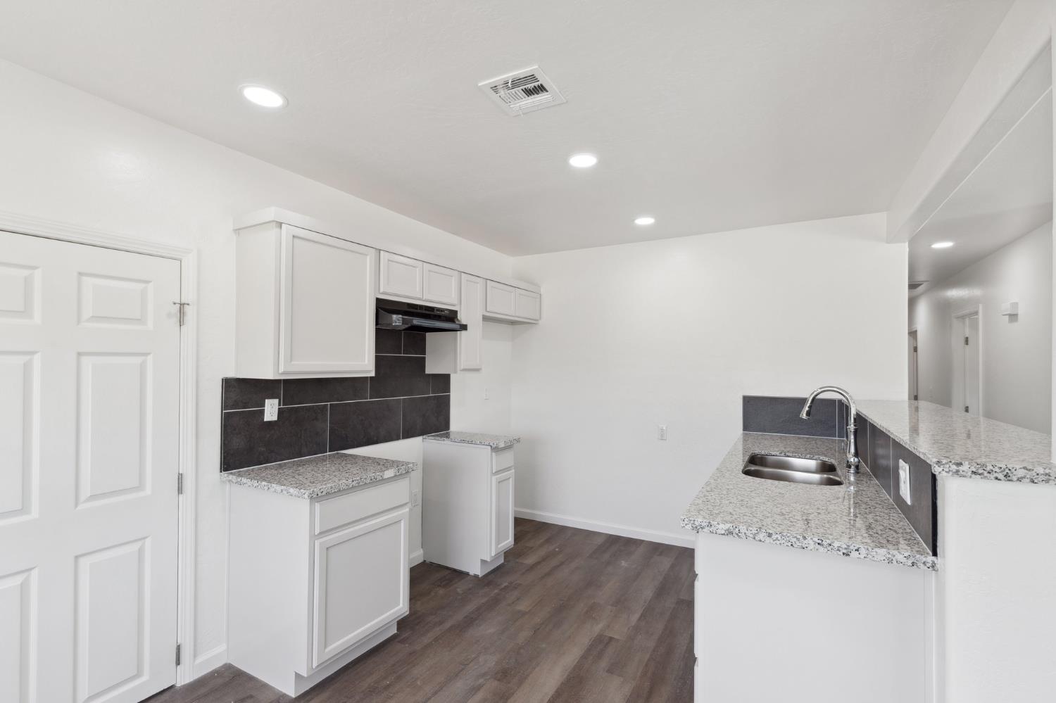 27747 Echo Road Madera, CA 93638 - Photo 15 of 38 a kitchen with granite countertop a sink and refrigerator