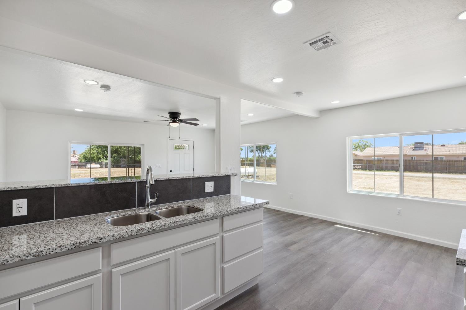 27747 Echo Road Madera, CA 93638 - Photo 16 of 38 a spacious bathroom with a granite countertop sink and a large mirror