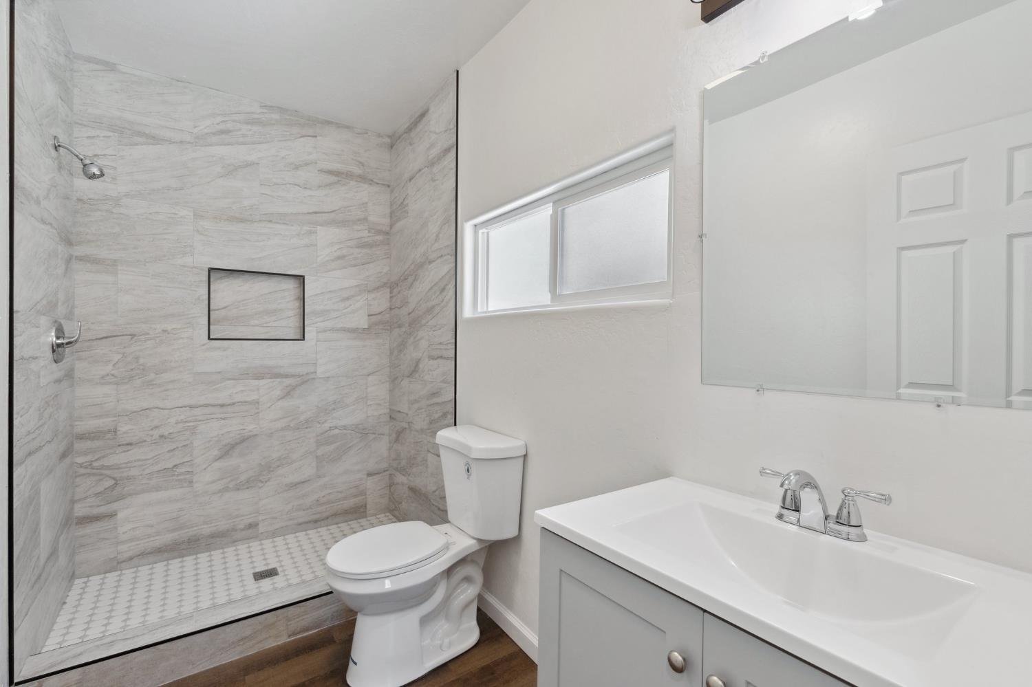 27747 Echo Road Madera, CA 93638 - Photo 22 of 38 a bathroom with a sink toilet and shower