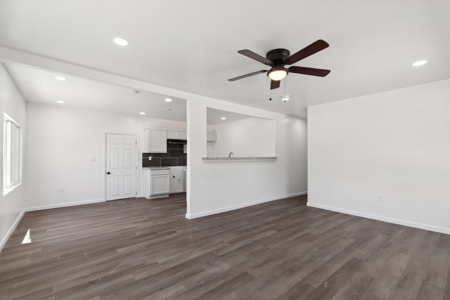 27747 Echo Road Madera, CA 93638 - Photo 9 of 38 a view of an empty room with a kitchen