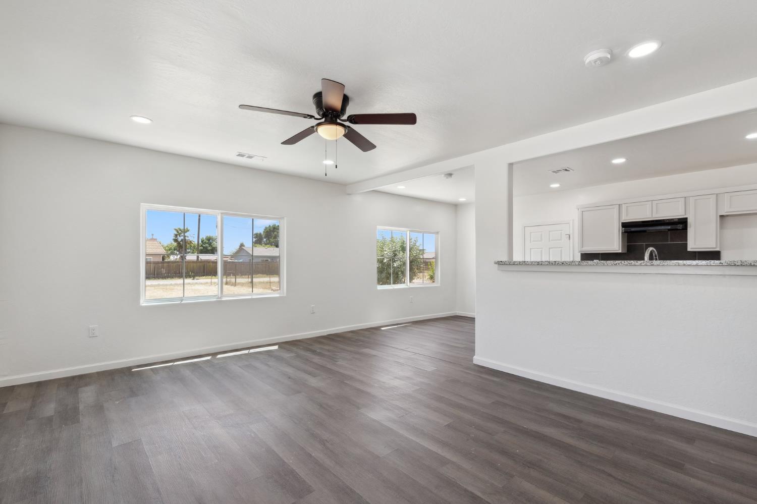 27747 Echo Road Madera, CA 93638 - Photo 10 of 38 a view of an empty room with window and wooden floor