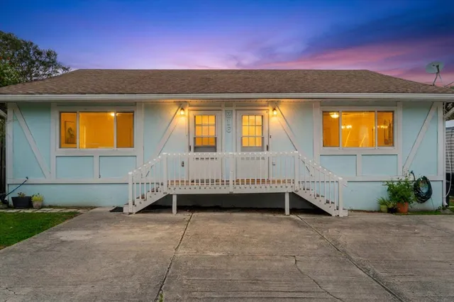 a view of a house with a tub and wooden fence