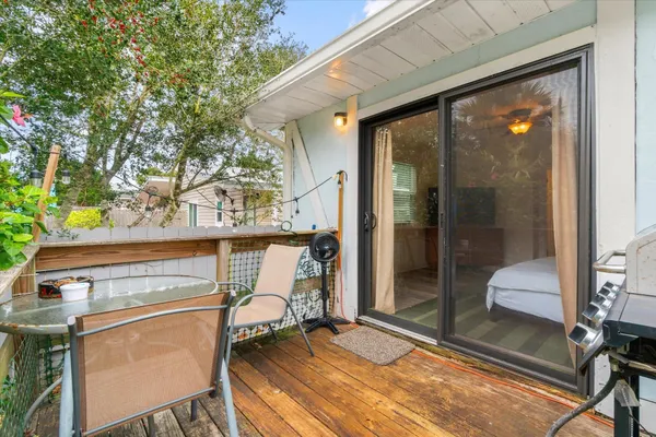 a view of a balcony with chair and front door
