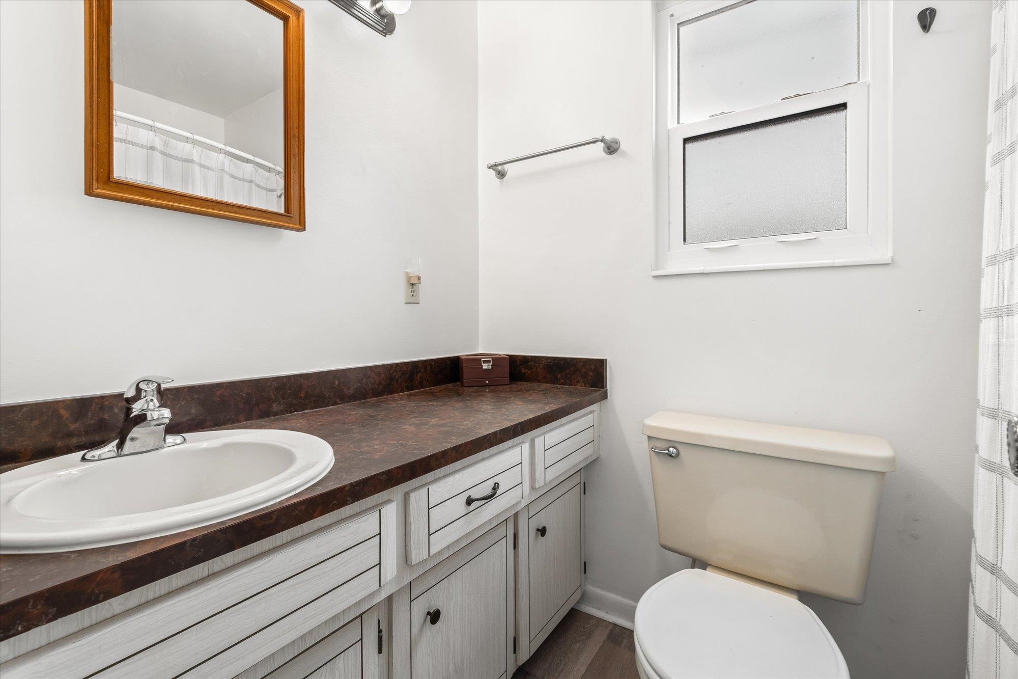 216 9th Street St. Augustine, FL 32080 - Photo 16 of 35 a bathroom with a granite countertop toilet sink and mirror