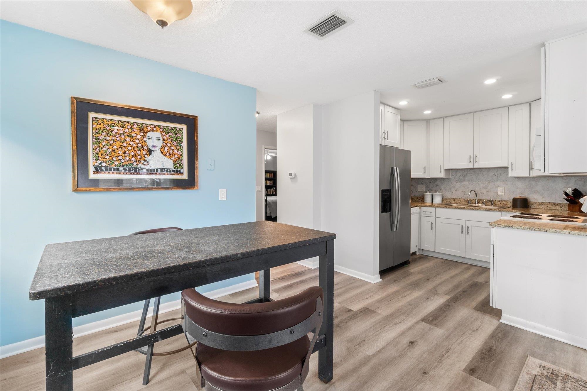 216 9th Street St. Augustine, FL 32080 - Photo 20 of 35 a kitchen with a table and chairs in it