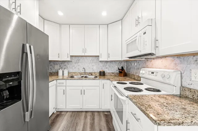 a kitchen with a sink stove and refrigerator