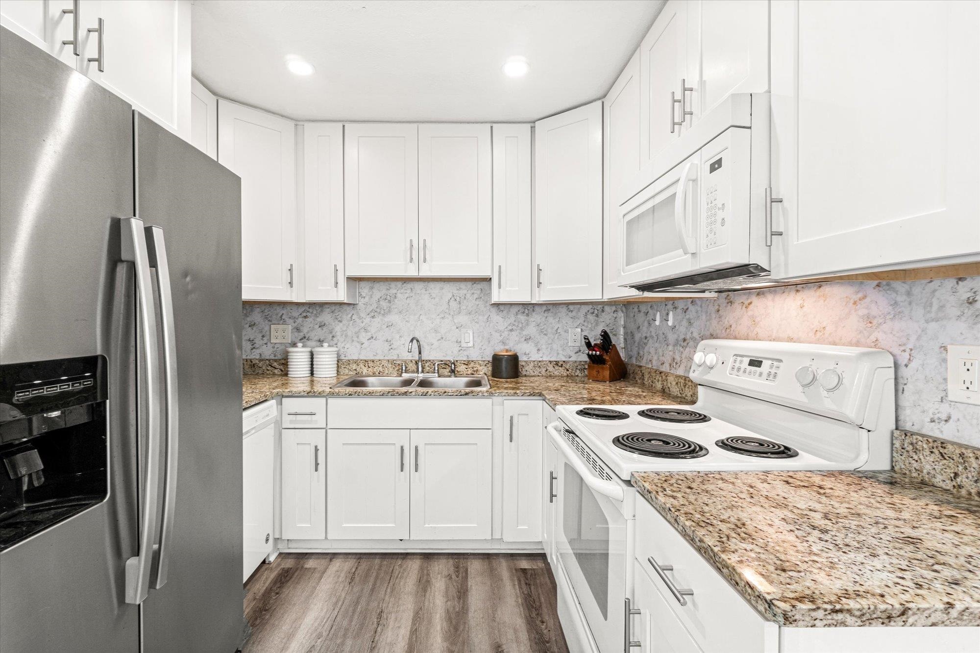 216 9th Street St. Augustine, FL 32080 - Photo 23 of 35 a kitchen with a sink stove and refrigerator