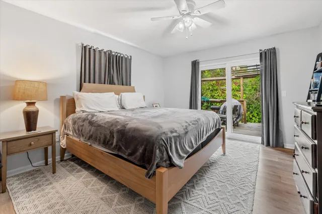 a bedroom with a bed lamp and a flat screen tv