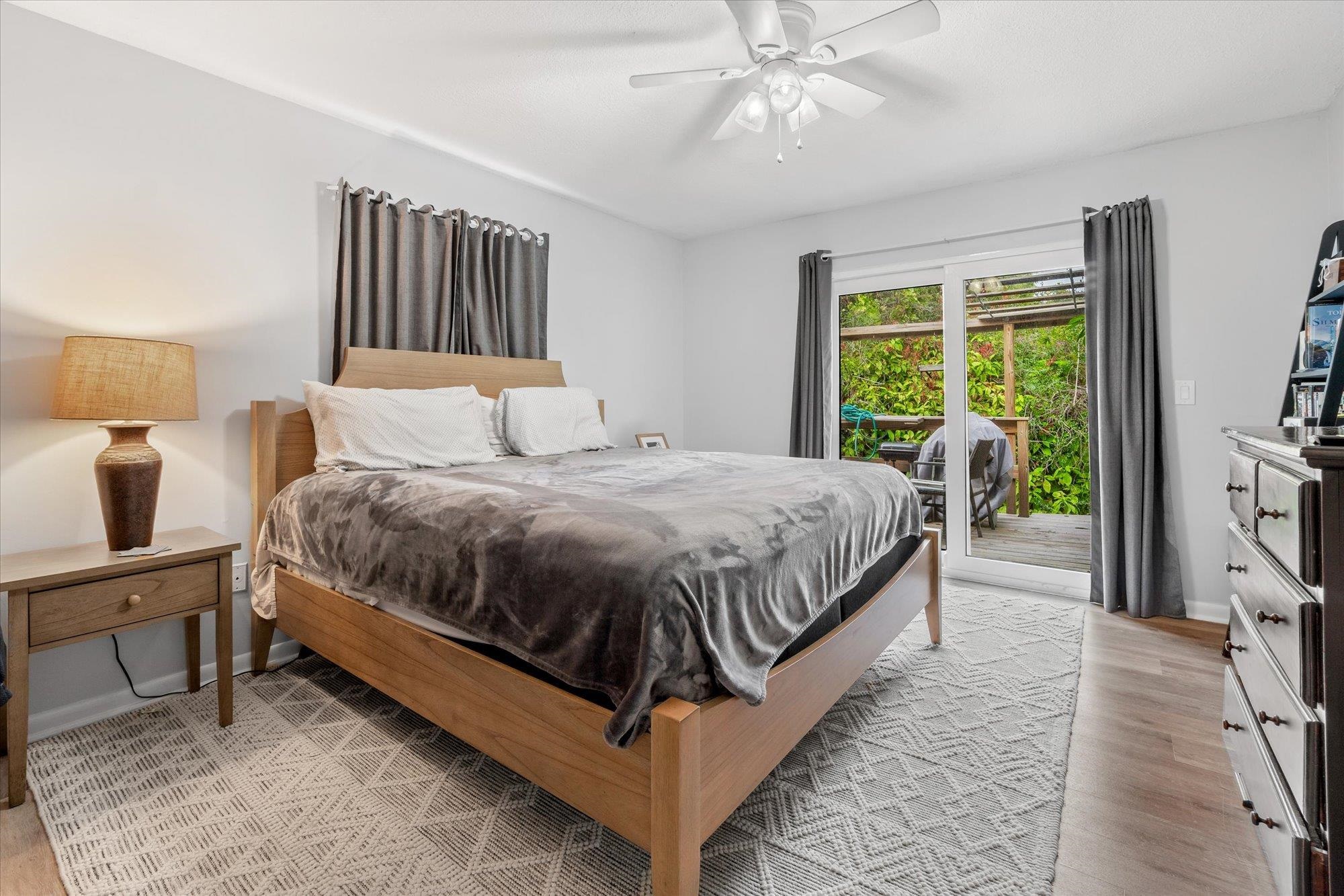 216 9th Street St. Augustine, FL 32080 - Photo 24 of 35 a bedroom with a bed lamp and a flat screen tv