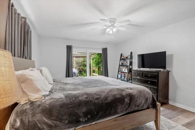 a bedroom with a large bed and a flat tv screen on a dresser