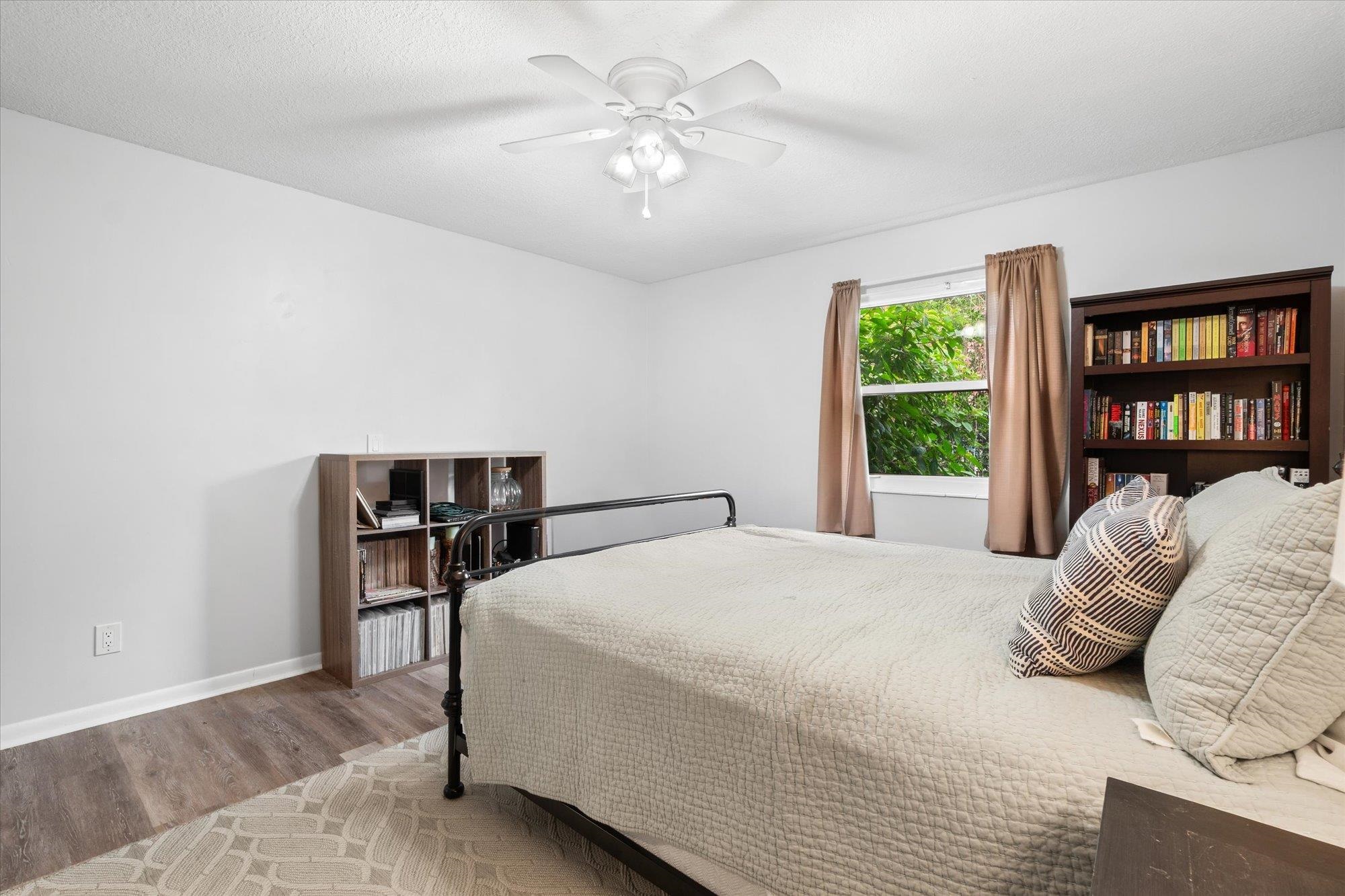 216 9th Street St. Augustine, FL 32080 - Photo 27 of 35 a bedroom with a bed and a chandelier