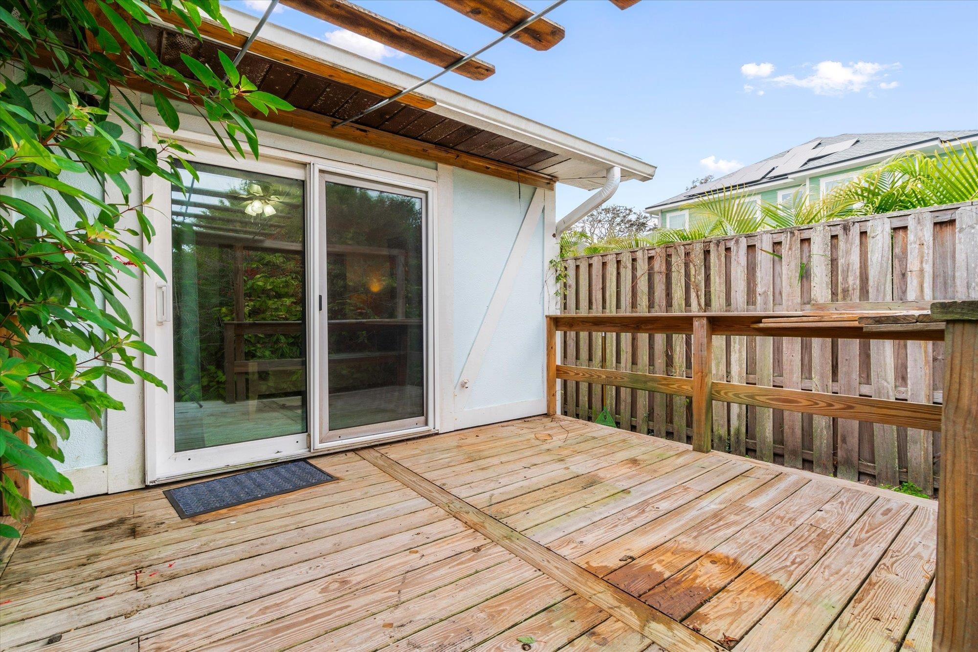 216 9th Street St. Augustine, FL 32080 - Photo 30 of 35 a bedroom with a bed and wooden floor