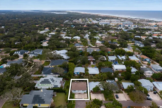 an aerial view of residential houses with city view