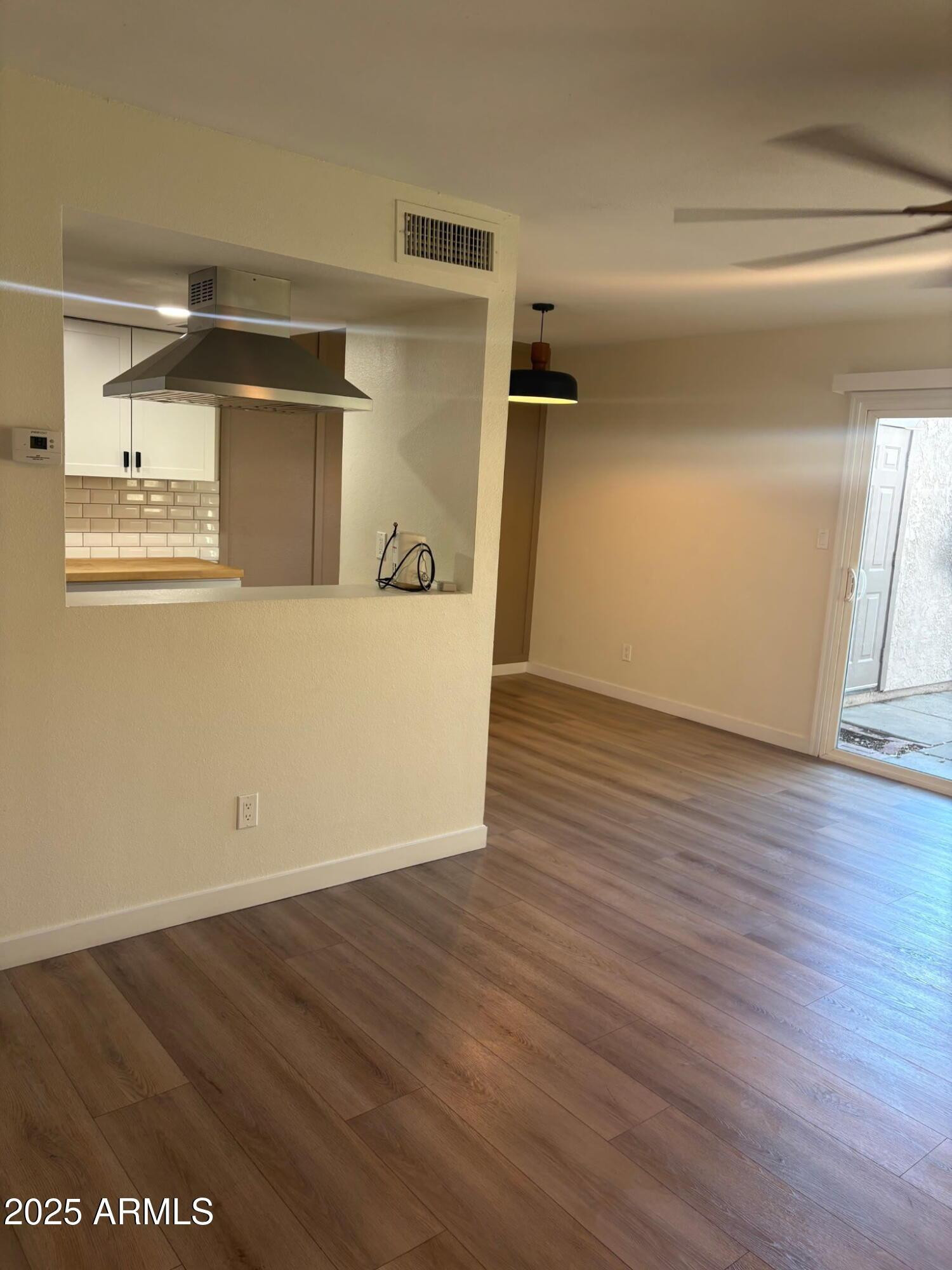 600 South Dobson Road, Unit 79 Mesa, AZ 85202 - Photo 2 of 11 a view of a refrigerator in kitchen and an empty room
