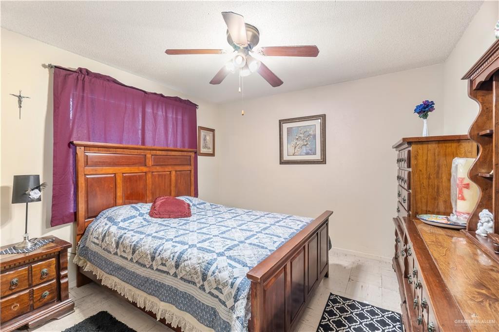 202 North Ester Street Edcouch, TX 78538 - Photo 5 of 13 a bedroom with a bed and a dresser with wooden floor