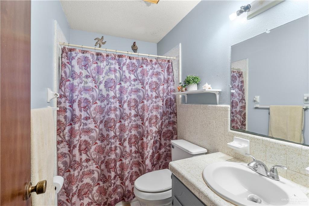 202 North Ester Street Edcouch, TX 78538 - Photo 10 of 13 a bathroom with a sink toilet and mirror