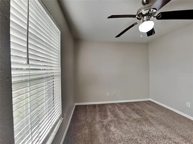 a view of a chandelier fan and wooden floor