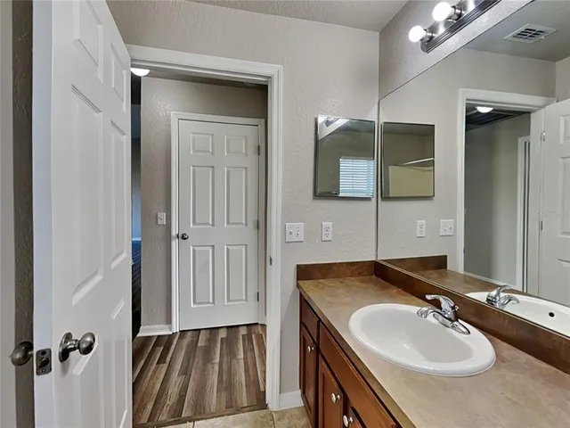 a bathroom with a sink a vanity and a mirror