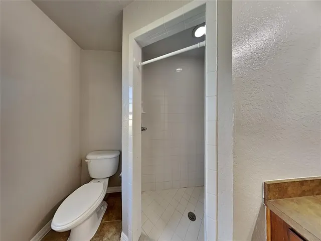 a white toilet sitting next to a bathroom sink
