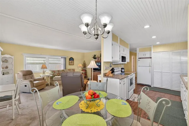 a view of a dining room with furniture and chandelier
