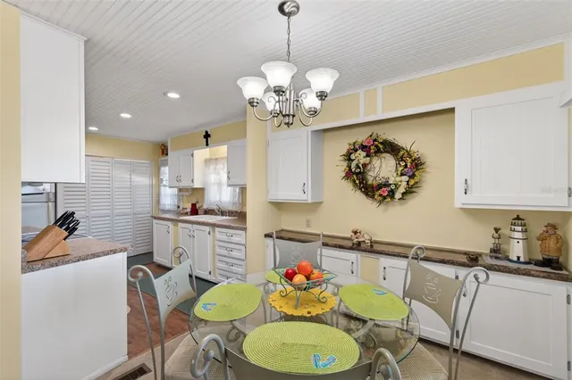 a kitchen with granite countertop a sink a stove and cabinets