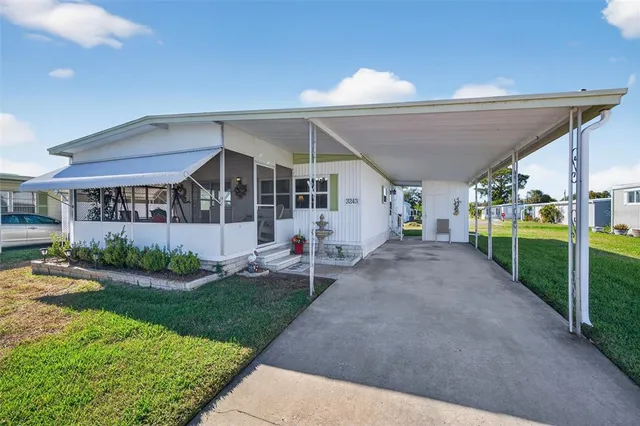 a view of a house with a yard and porch
