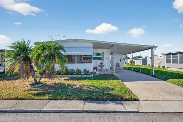 a front view of a house with a garden and patio