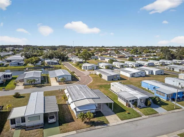 an aerial view of a residential building with swimming pool