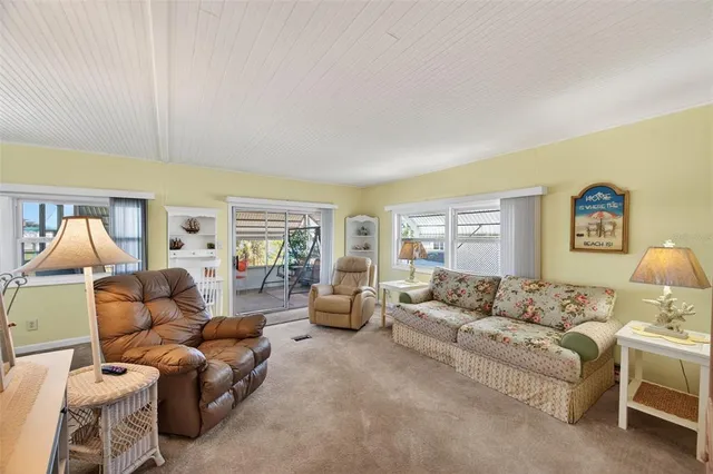 a bedroom with furniture and a large window