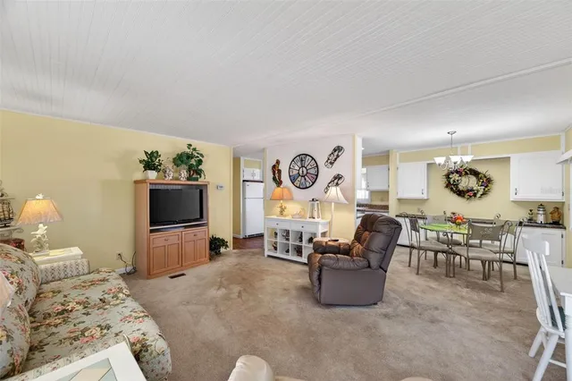 a dining room with furniture a livingroom view and wooden floor