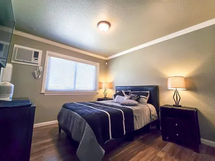 a bedroom with a bed and a lamp with window