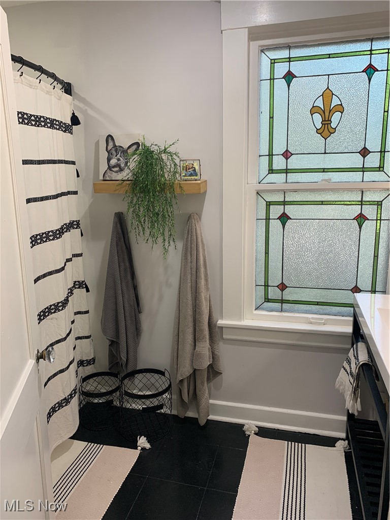 1509 Rydalmount Road Cleveland Heights, OH 44118 - Photo 8 of 12 Full bathroom featuring baseboards, a shower with shower curtain, tile patterned flooring, and vanity