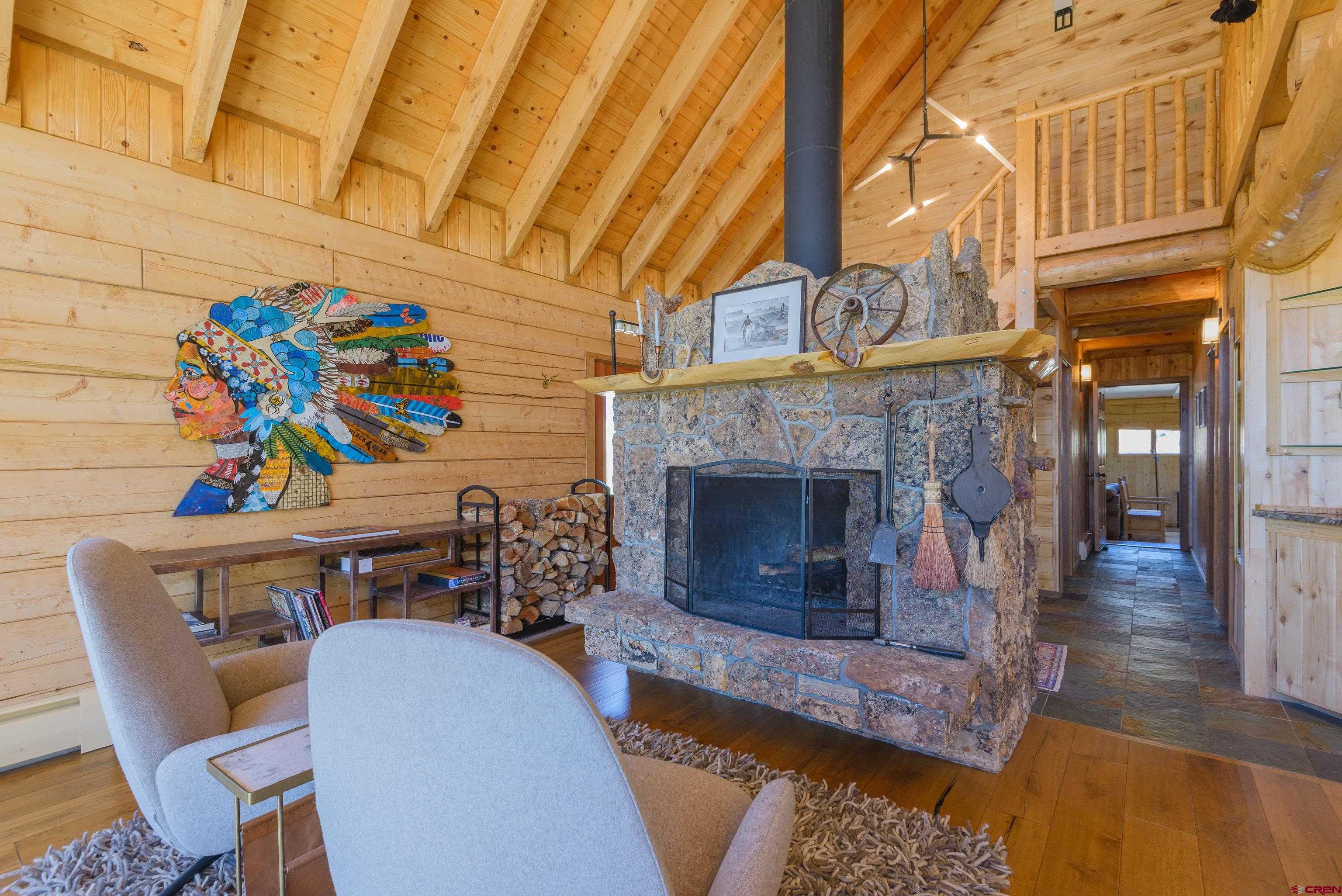 1250 County Road 734 Crested Butte, CO 81224 - Photo 11 of 45 a living room with furniture and a fireplace